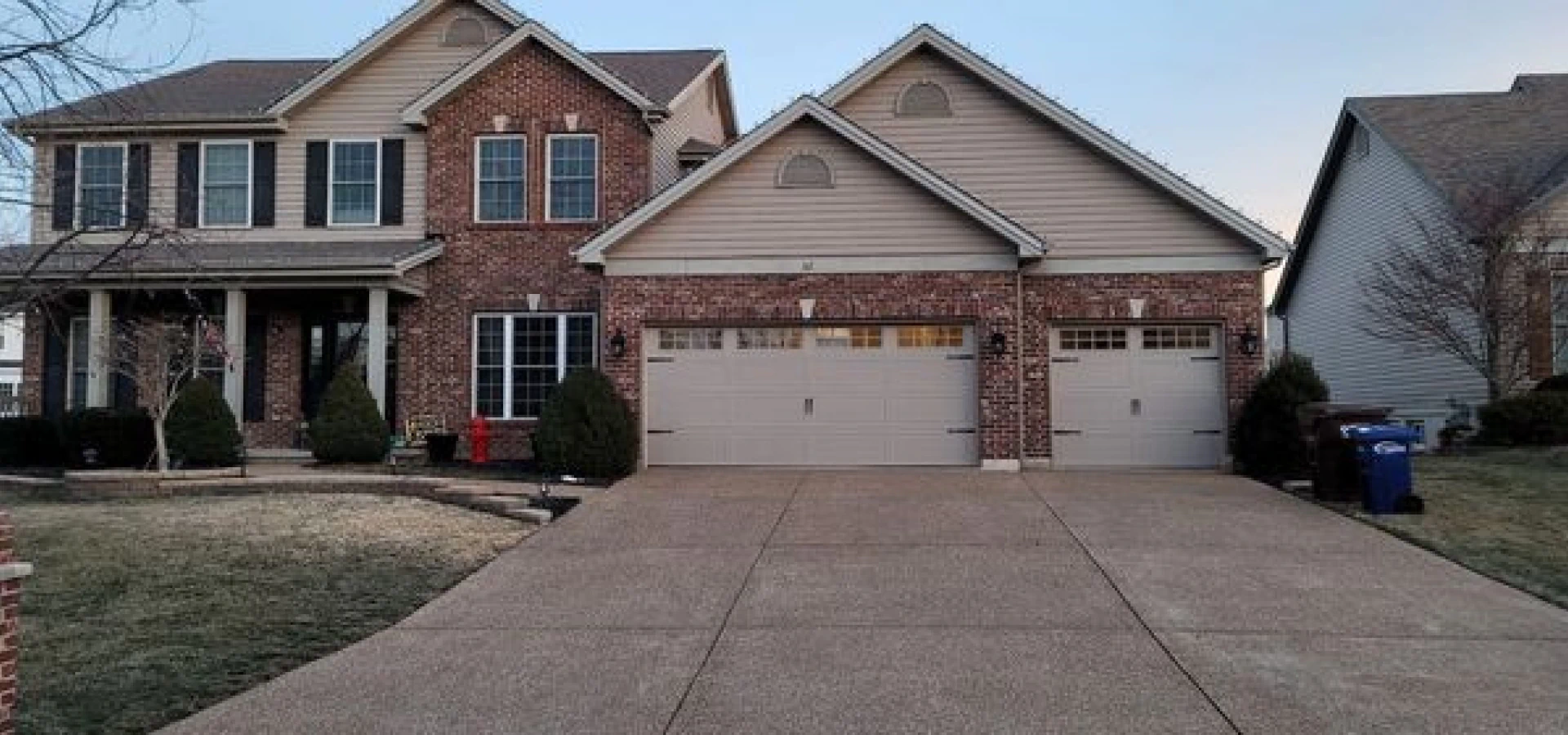 residential brick house with two door garage